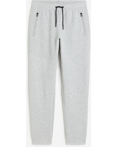 H&M Pantalon jogger tech DryMove avec poches zippées - Blanc