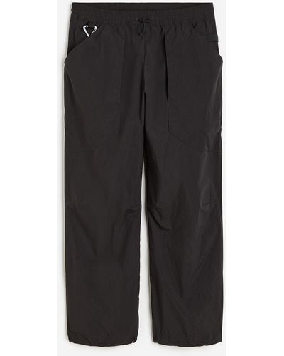H&M Sport-Joggpants aus wasserabweisendem Nylon - Schwarz