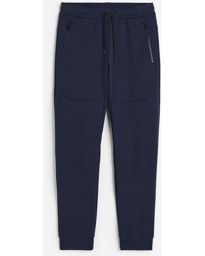 H&M Pantalon jogger tech DryMove avec poches zippées - Bleu