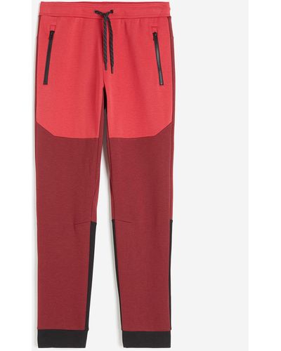 H&M DryMoveTM Tapered Tech-Joggpants mit Zippertaschen - Rot