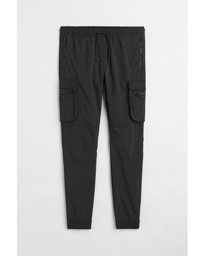 H&M Pantalon jogger cargo Skinny Fit en nylon - Noir