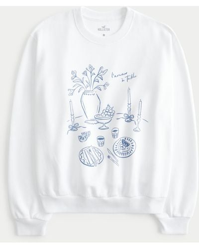 Hollister Lässiges Sweatshirt mit Rundhalsausschnitt und L'Amour à Table-Grafik - Weiß