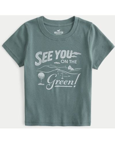 Hollister Geripptes Baby-Tee mit See You On the Green Golf-Grafik - Blau