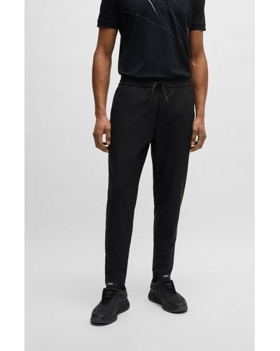 BOSS Pantalon Tapered Fit en matière softshell imperméable - Noir