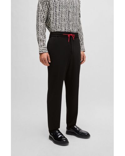 HUGO Pantalon Extra Slim Fit en jersey stretch performant avec cordon de serrage - Noir