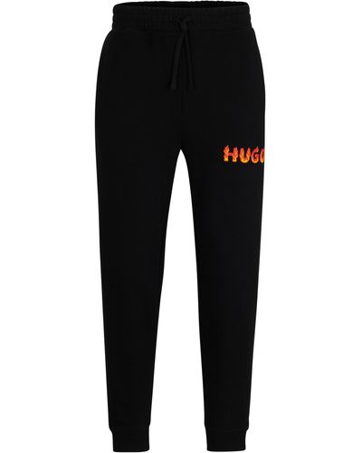 HUGO Jogginghose aus Baumwoll-Terry mit gepufftem Flammen-Logo - Schwarz