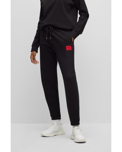 HUGO Pantalones de chándal en felpa de algodón con etiqueta con logo - Negro