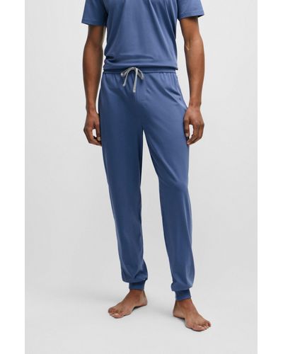 Homme Pantalon d’intérieur en coton stretch resserré au bas des jambes,  avec logo brodé Bleu | Vêtements de nuit et vêtements d’intérieur HUGO BOSS  <