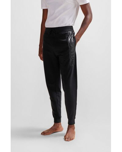 BOSS Pantalon de survêtement en molleton resserré au bas des jambes, avec logo imprimé - Noir