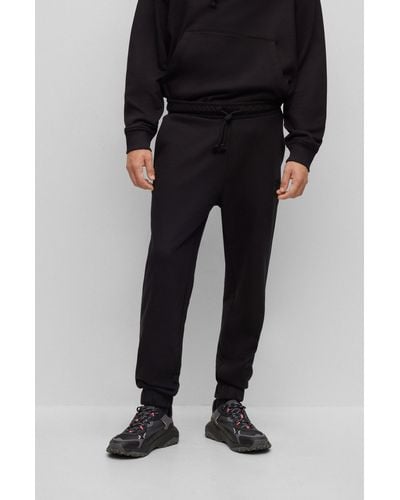 HUGO Relaxed-fit Cotton-terry Tracksuit Bottoms With Stacked Logo - Black