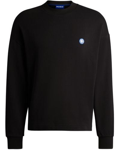 HUGO Sweatshirt aus Baumwoll-Terry mit dem Logo-Aufnäher der neuen Saison - Schwarz