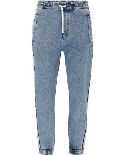 HUGO Tapered-Fit Jeans mit Beinbündchen und Logo-Tape - Blau