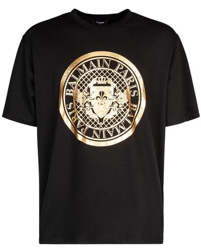 Balmain Oversize-T-Shirt aus Baumwolle mit aufgedrucktem Metallic-Logo in Form einer Münze - Schwarz