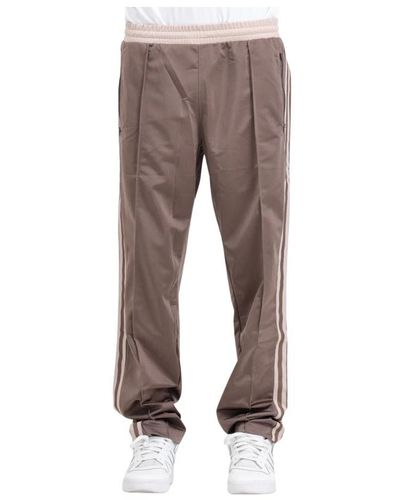adidas Originals Pantaloni marroni track pants con tasche con zip - Grigio