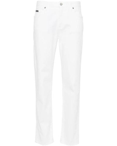 Dolce & Gabbana Vaqueros de denim de algodón elástico blanco con pierna cónica