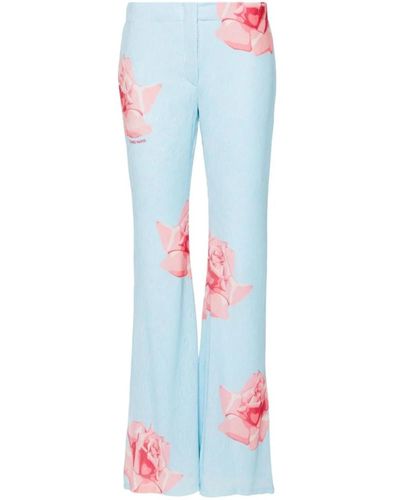 KENZO Pantalones azules con estampado de rosas y diseño acampanado