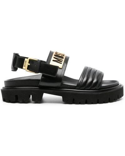 Moschino Schwarze gesteppte sandalen mit goldenem logo
