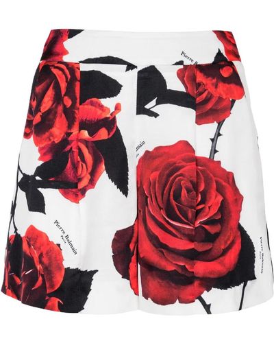 Balmain Shorts de satén con estampado de rosas rojas - Rojo