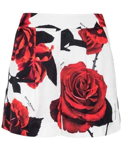 Balmain Shorts de satén con estampado de rosas rojas - Rojo