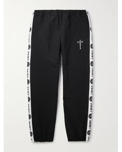 SAINT Mxxxxxx Tapered Logo-embroidered Striped Nylon-twill Track Trousers - Black