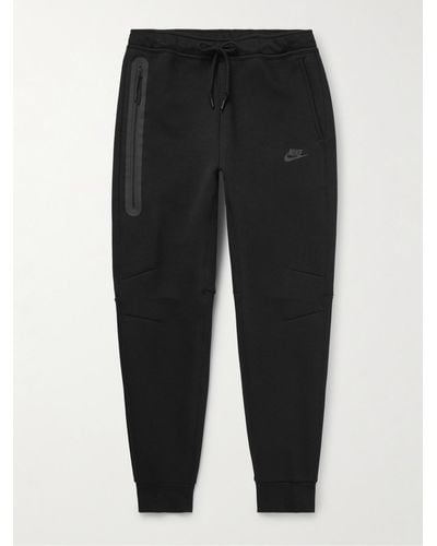 Nike Pantaloni sportivi a gamba affusolata in Tech Fleece di misto cotone con logo - Nero