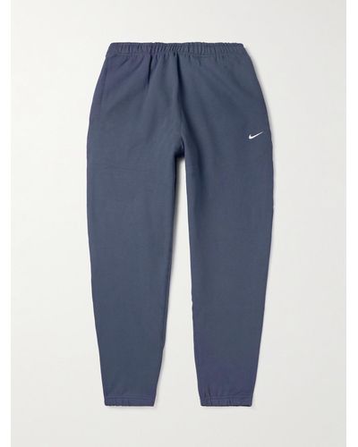 Nike Solo Swoosh schmal zulaufende Jogginghose aus Jersey aus einer Baumwollmischung mit Logostickerei - Blau