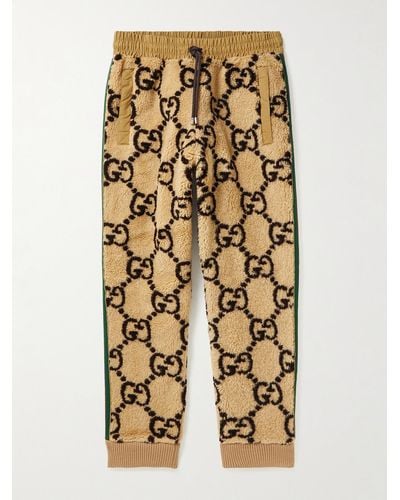 Gucci Jogginghose aus Fleece aus einer Wollmischung mit Logomuster und Streifen - Braun