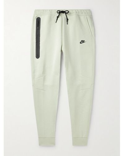 Nike Pantaloni sportivi a gamba affusolata in Tech Fleece di misto cotone con logo - Blu