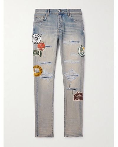 Amiri Schmal geschnittene Jeans mit Applikationen in Distressed-Optik - Blau