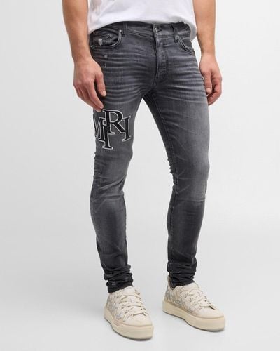 Amiri Faded Skinny Jeans With Staggered Logo - Blue