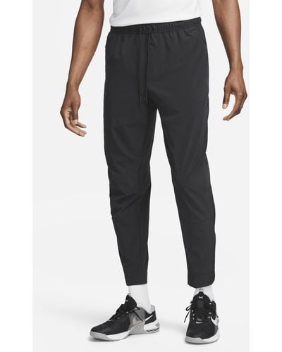 Nike Pantaloni versatili con zip sul bordo dri-fit unlimited - Nero