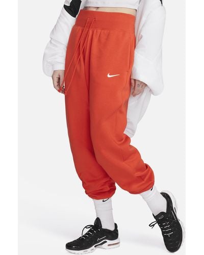Nike Pantaloni tuta oversize a vita alta sportswear phoenix fleece - Rosso