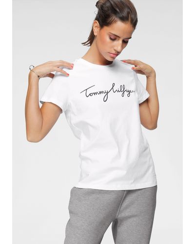 Tommy Hilfiger T-Shirt HERITAGE CREW NECK GRAPHIC TEE mit Script -Schriftzug & Logo-Flag am Saum - Weiß