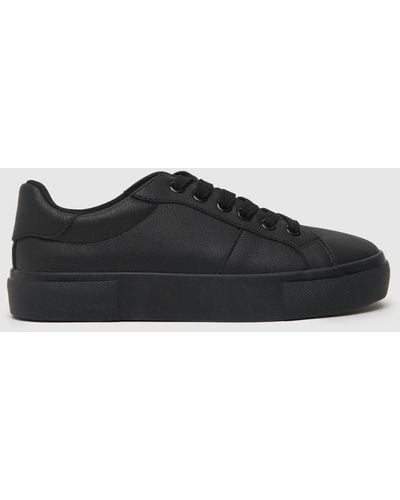 Schuh Nadine Lace Up Trainers In - Black