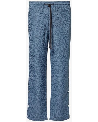 Song For The Mute Floral-pattern Relaxed-fit Woven jogging Bottoms - Blue