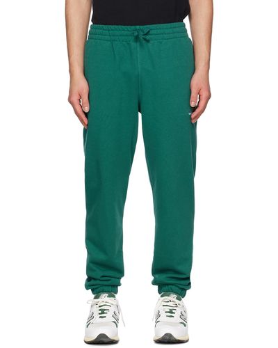 New Balance Pantalon de détente uni-ssentials vert