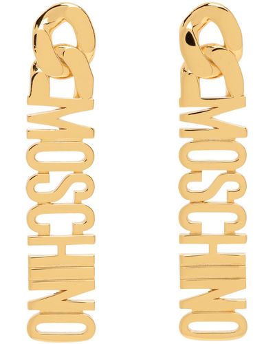 Moschino Boucles d'oreilles pendantes dorées à logo - Métallisé