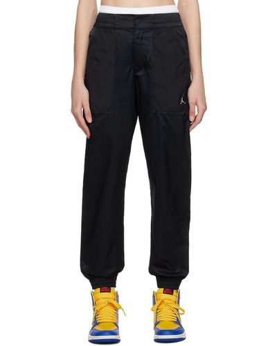 Nike Pantalon de détente noir à logo brodé