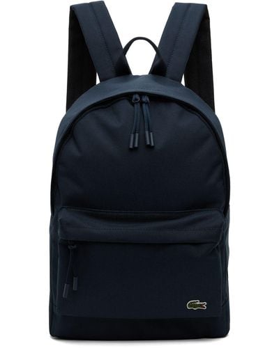Shop LACOSTE Unisex Plain Logo Backpacks by 爽風modeinNY