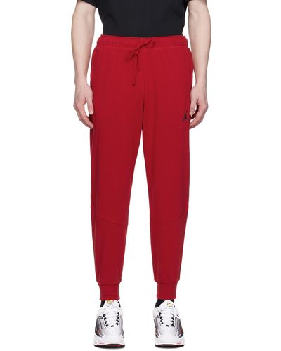 Nike Pantalon de survêtement de sport rouge à technologie dri-fit