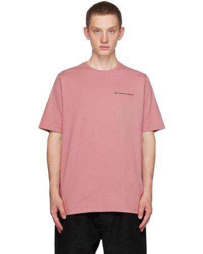 Pop Trading Co. T-shirt rose à logos imprimés