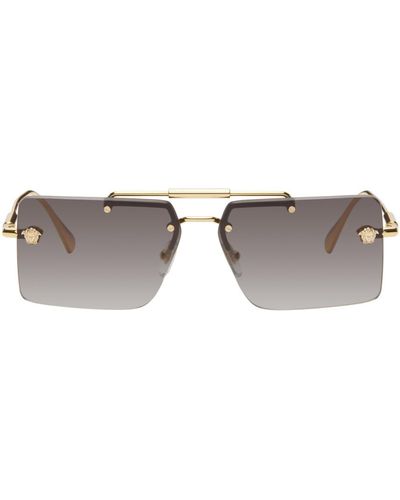 Versace Lunettes de soleil dorées à ferrures à méduse - Noir