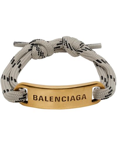 Balenciaga Bracelet gris et doré à plaque à logo - Métallisé