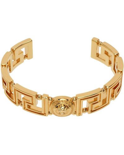 Versace Bracelet manchette doré à méduse et à motif à clé grecque - Métallisé