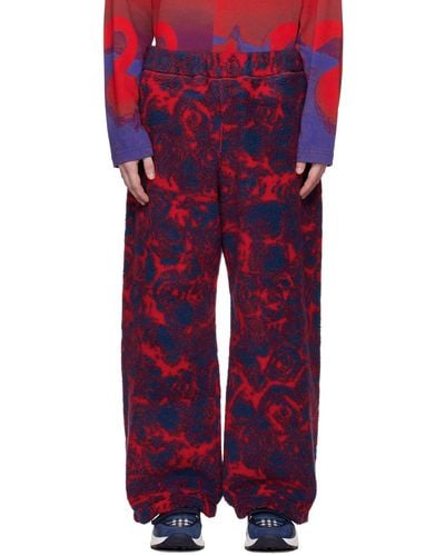 Burberry Pantalon rouge et bleu à motif de roses