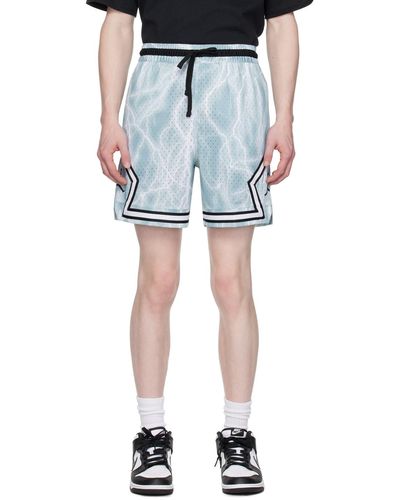 Nike Short de sport bleu et blanc à rayures