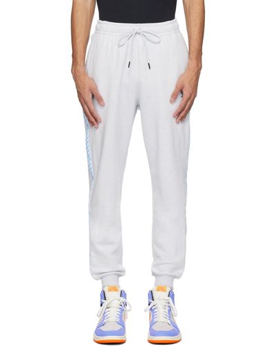 Nike Pantalon de survêtement gris à logo brodé - Blanc
