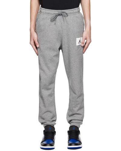 Nike Pantalon de survêtement gris à étiquette à logo - Multicolore