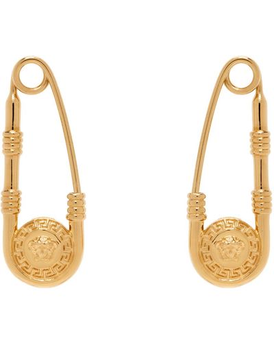Versace Boucles d'oreilles de style épingle de sureté dorées - Métallisé