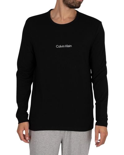 https://cdna.lystit.com/400/500/tr/photos/stand-out/5b080fda/calvin-klein-Black-Lounge-Graphic-Longsleeved-T-shirt.jpeg